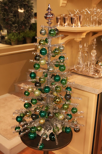 A silver tinsel tree with green balls