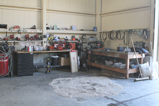 This corner of the barn is reserved for mechanical maintenance and repairs. One of the vehicles had an oil leak and an oil absorbent was spread over the puddle to soak it up.