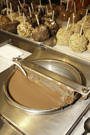 A tempered melter full of milk chocolate