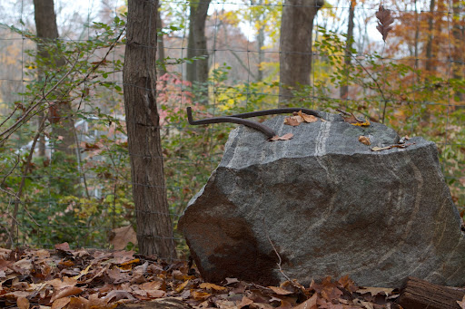 This appears to be a forged iron hinge, bored into a stone, where a gate once swung.
