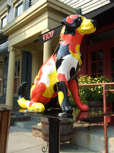 We've had a couple of 'dog parades' in which local artists painted dog statues all along Warren Street. This pooch, at our doorstep, is by the artist, Jack Millard and his name is Poochi!