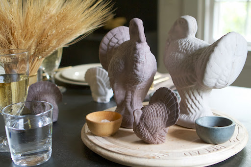 Old English carved breadboards held the turkey sculptures, as well as various small stone vessels for salt and pepper.